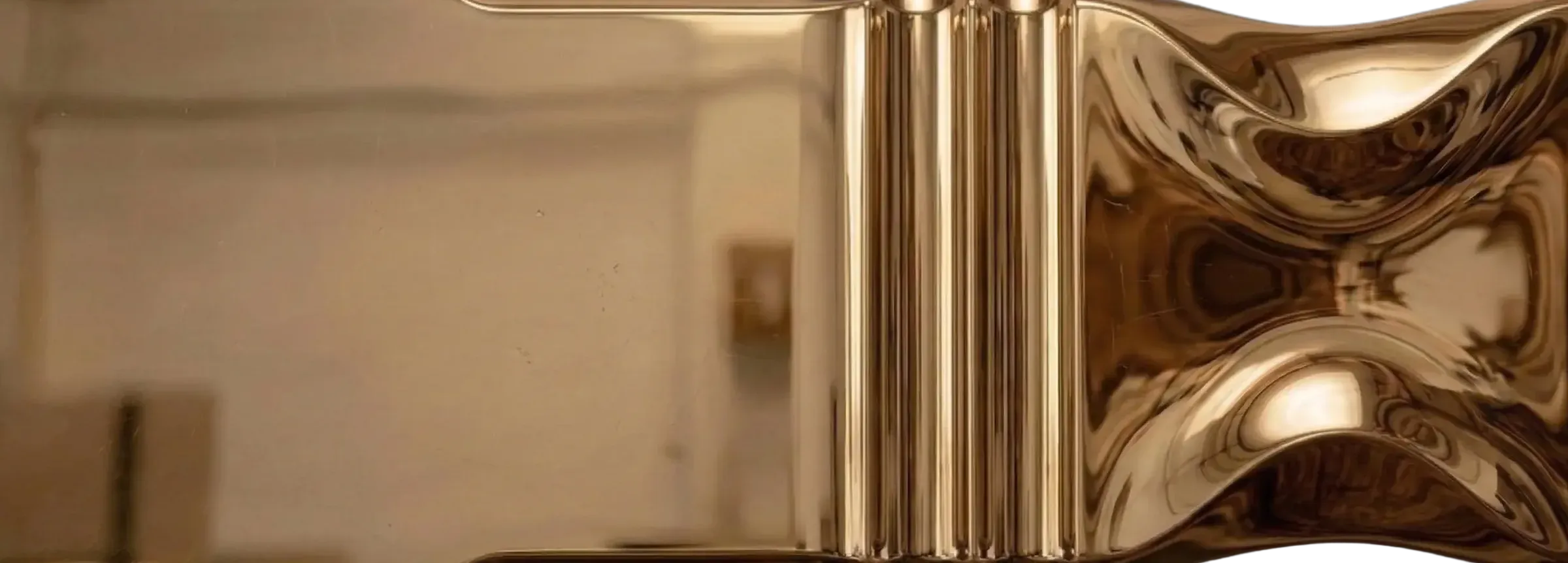 Polished Bronze liquid metal finish sample with high gloss reflective bronze surface and sculpted ribbed detail